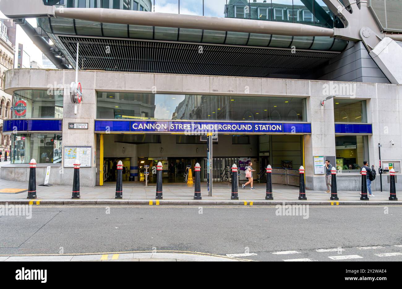 a-woman-walking-past-the-entrance-to-cannon-street-underground-station