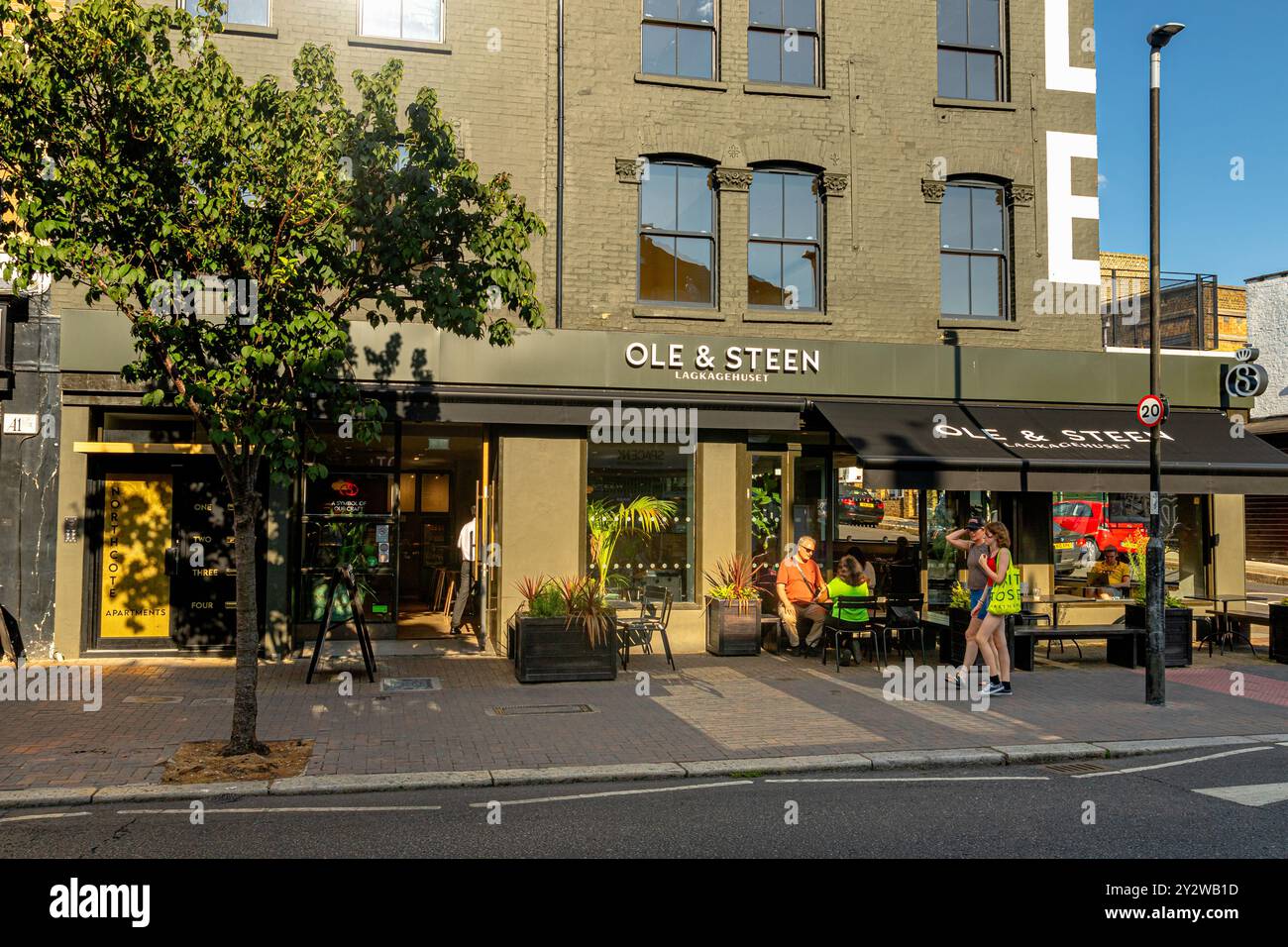 People sitting outside Ole & Steen a popular Danish Bakery on Northcote Road ,Clapham Junction, London,UK Stock Photo