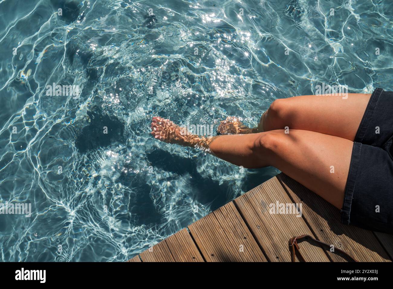 Woman refreshes in the pool at Manifesto Market, a must-visit cultural experience in the heart of Prague with pop-up design retail experience bars and Stock Photo