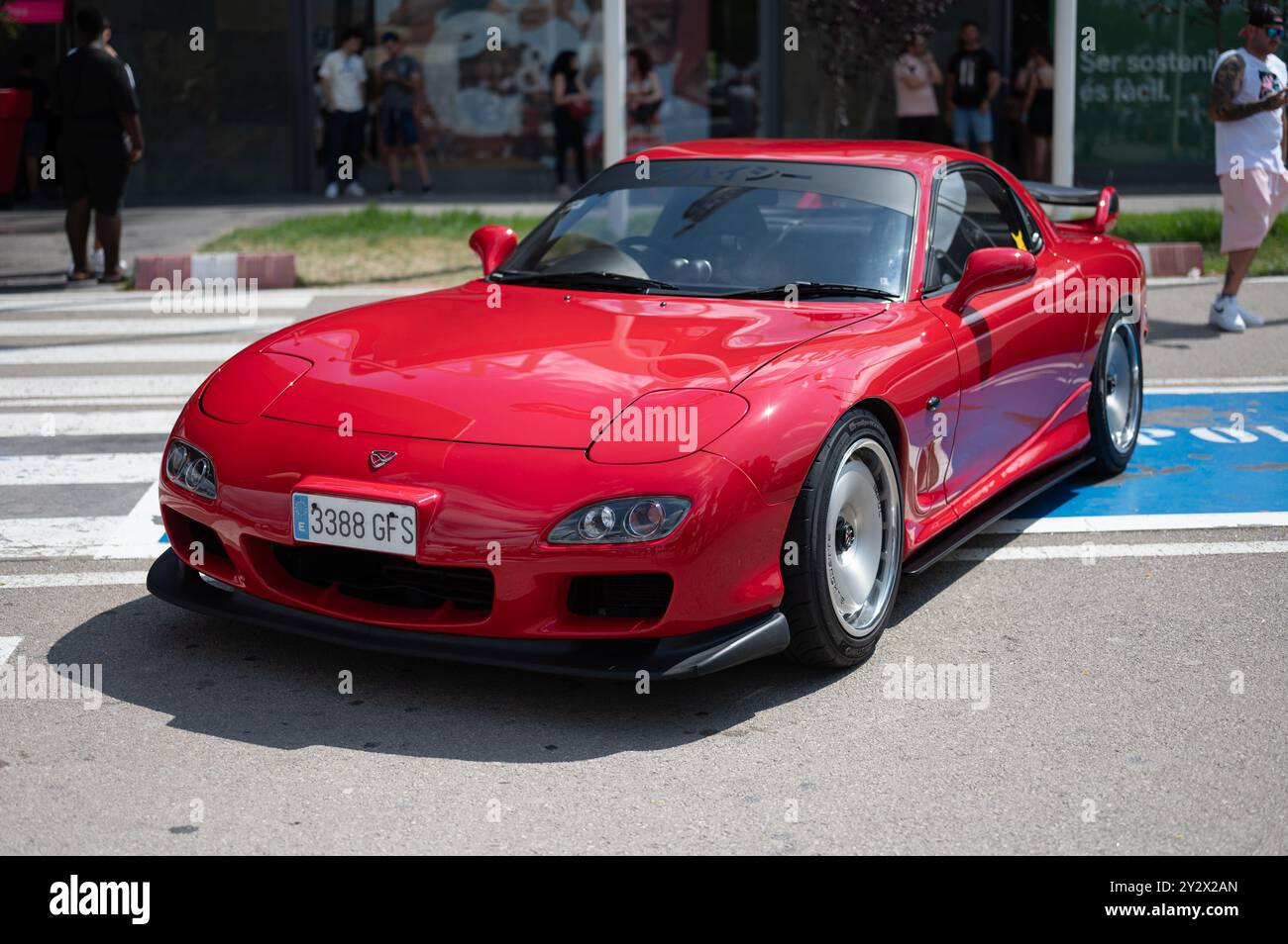 Spectacular third-generation Japanese imported Mazda RX-7 sports car. It is red with black spoiler and lip. Wankel type rotary engine Stock Photo