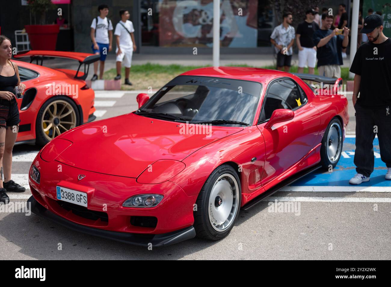 Mazda Rx-7 third generation red rotary engine at a car meeting, tuned in Japanese style for touge racing, Impul Silhouette wheels and bodykit Stock Photo