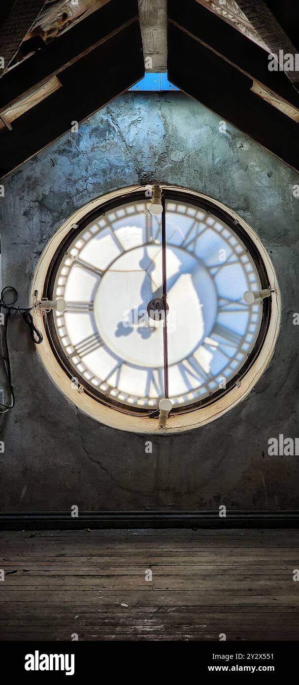 An interior view of a large clock face with shadows cast by the clock ...