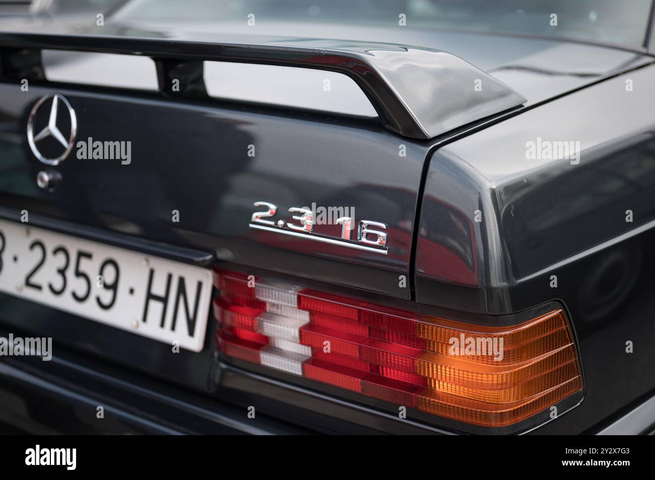 detail of the spoiler and 2.01 16V emblem of the classic German injection luxury sports car Mercedes Benz 190 E with W201 chassis. Stock Photo