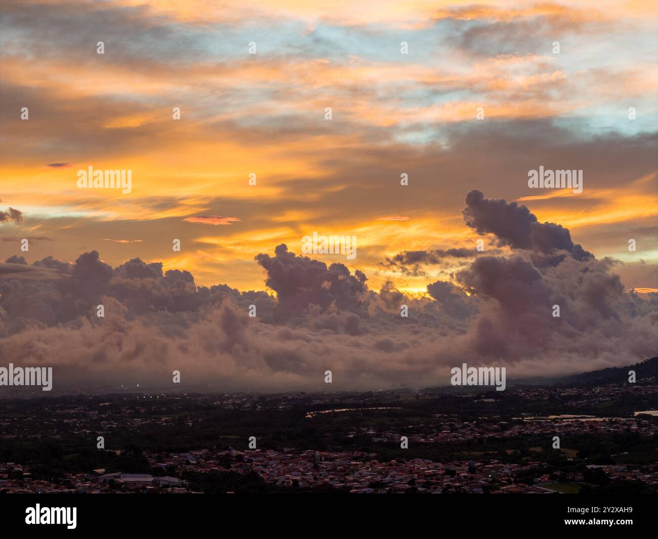 A stunning sunset with dramatic clouds over a cityscape, showcasing ...