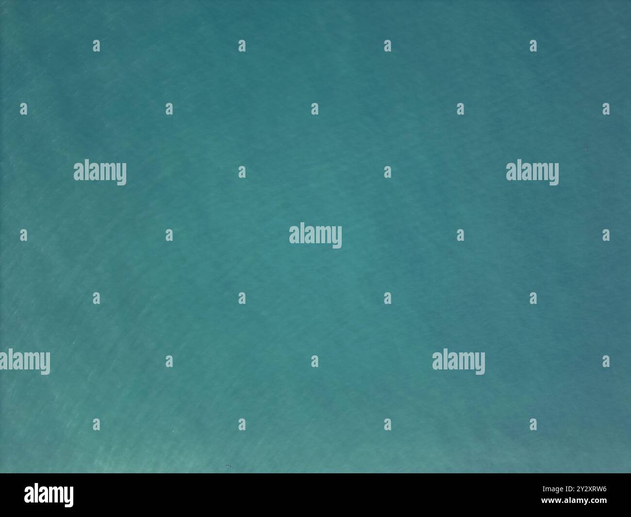 Green tropical sea water with small waves above top drone view Stock Photo