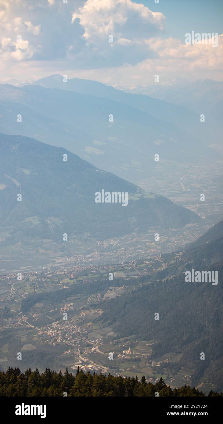 An aerial view of a picturesque mountain valley with small towns and ...