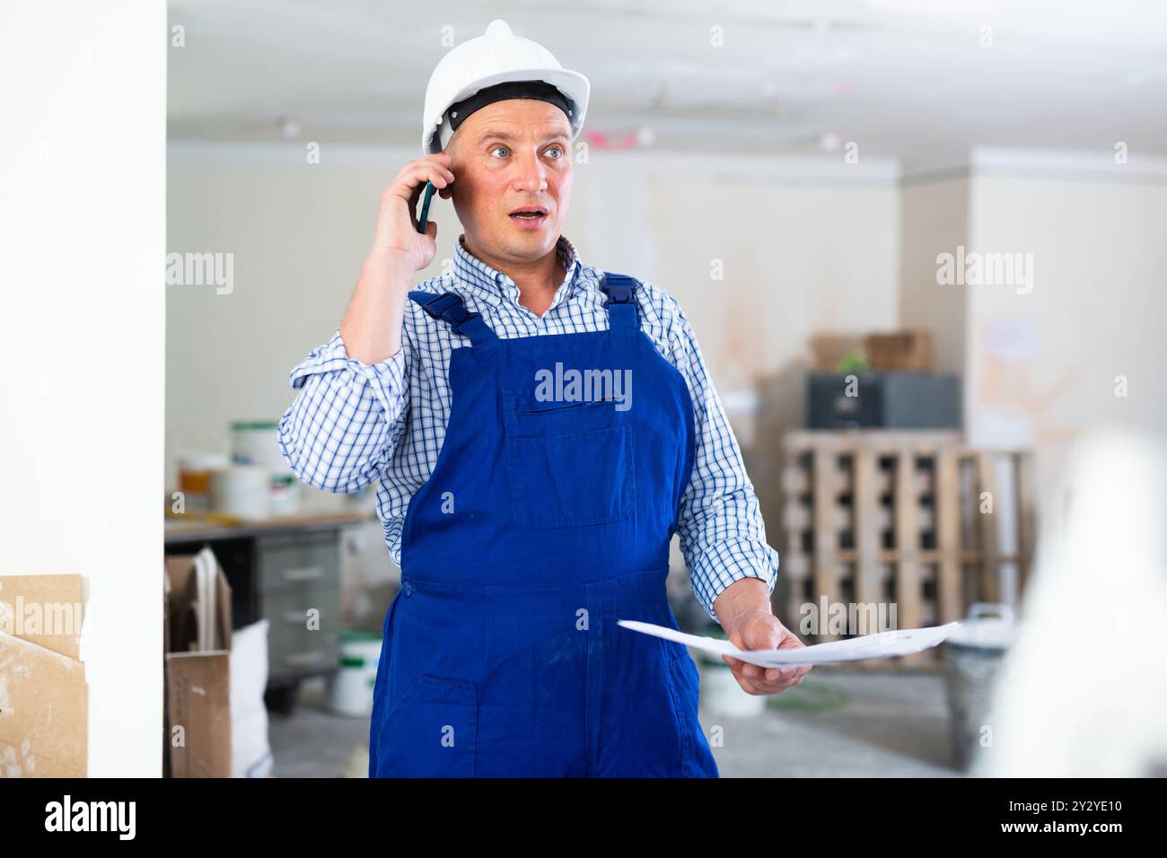 Construction worker having telephone conversation Stock Photo
