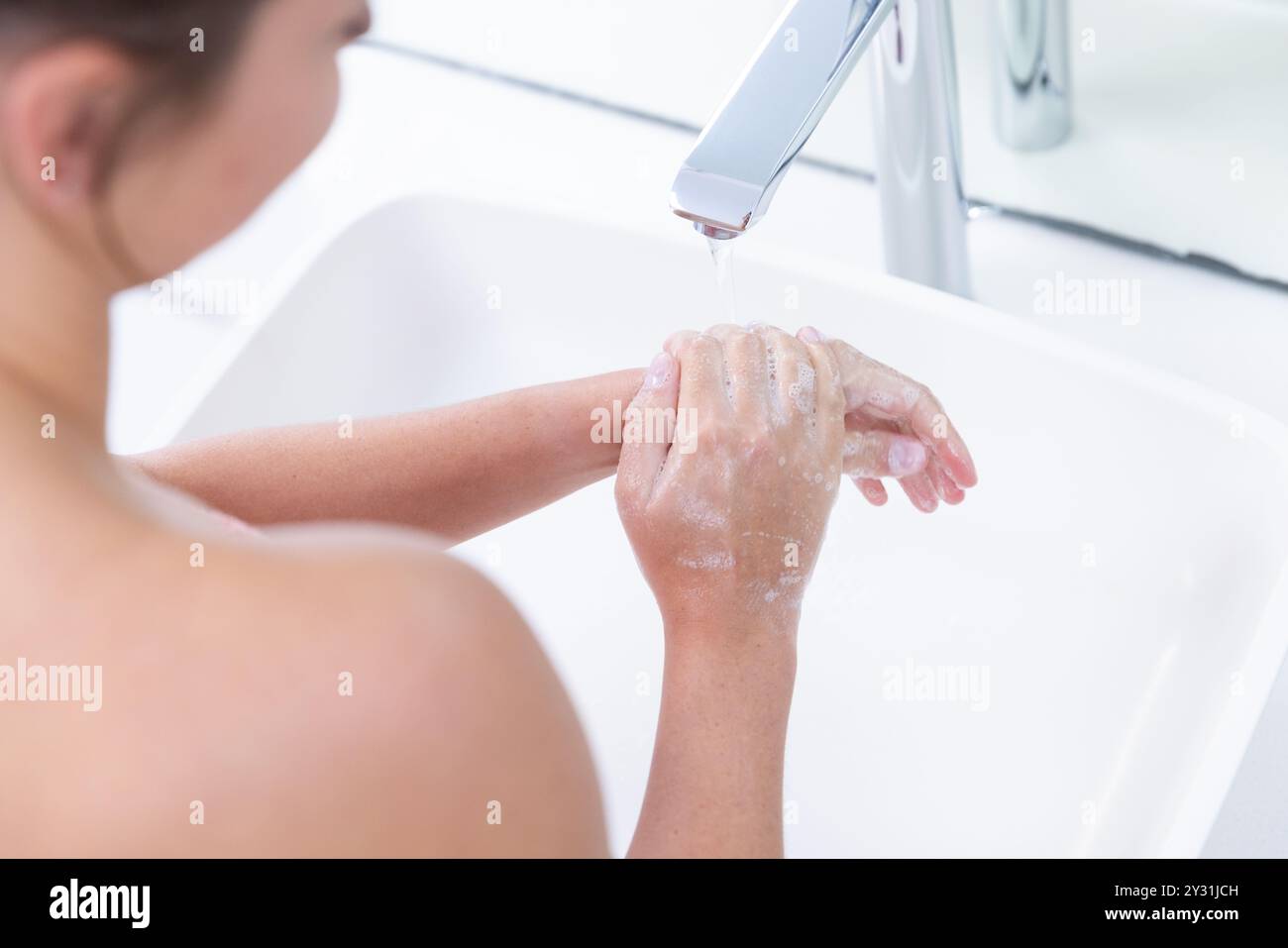 At home, Washing hands under running water, woman enjoying relaxing spa treatment Stock Photo