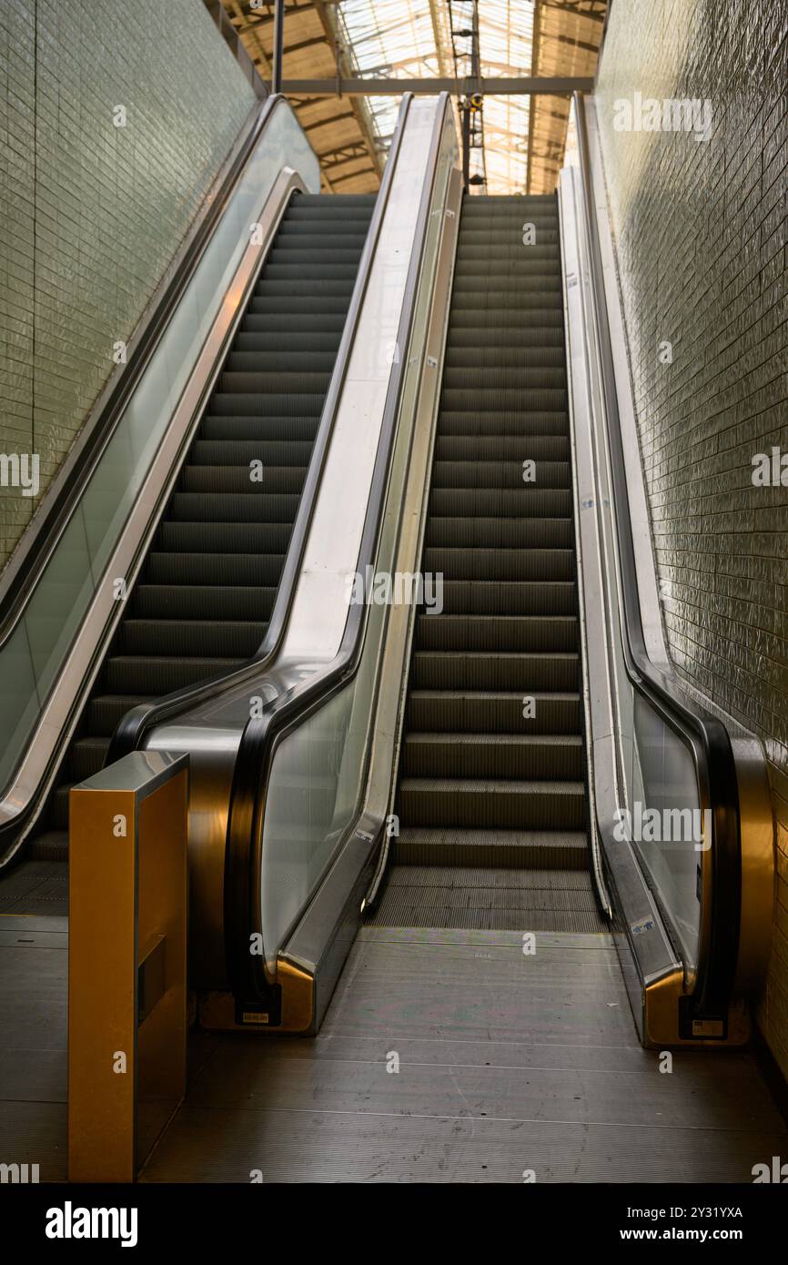 An escalator leading to a platform at Amsterdam Centraal Station, Amsterdam, The Netherlands Stock Photo