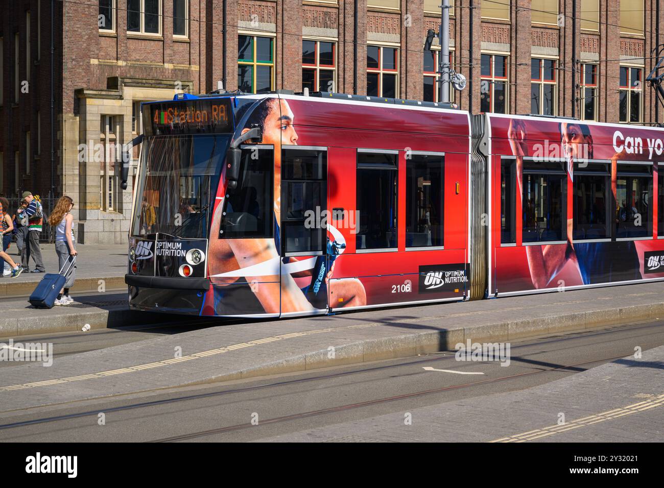 A stationary Dutch tram at Amsterdam Centraal Station on a sunny, summer day, Amsterdam, The Netherlands Stock Photo