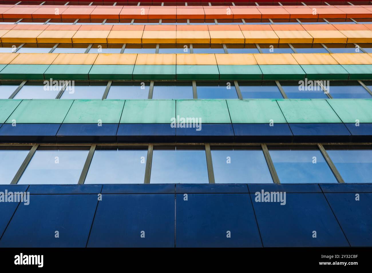 Colorful facade of modern building with horizontal stripes of red ...