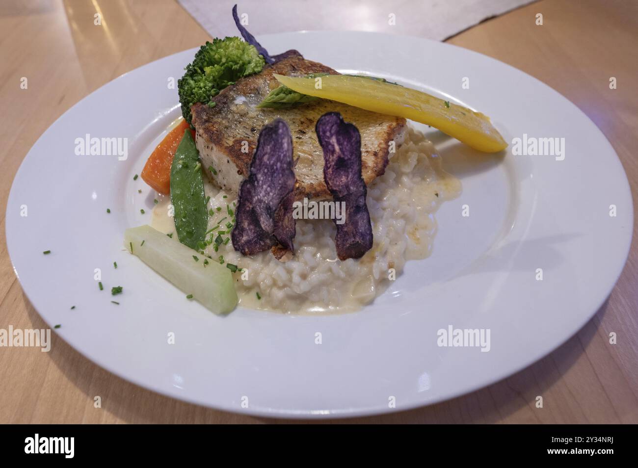 Veal steak with risotto and vegetables served in a restaurant, Bavaria, Germany, Europe Stock Photo