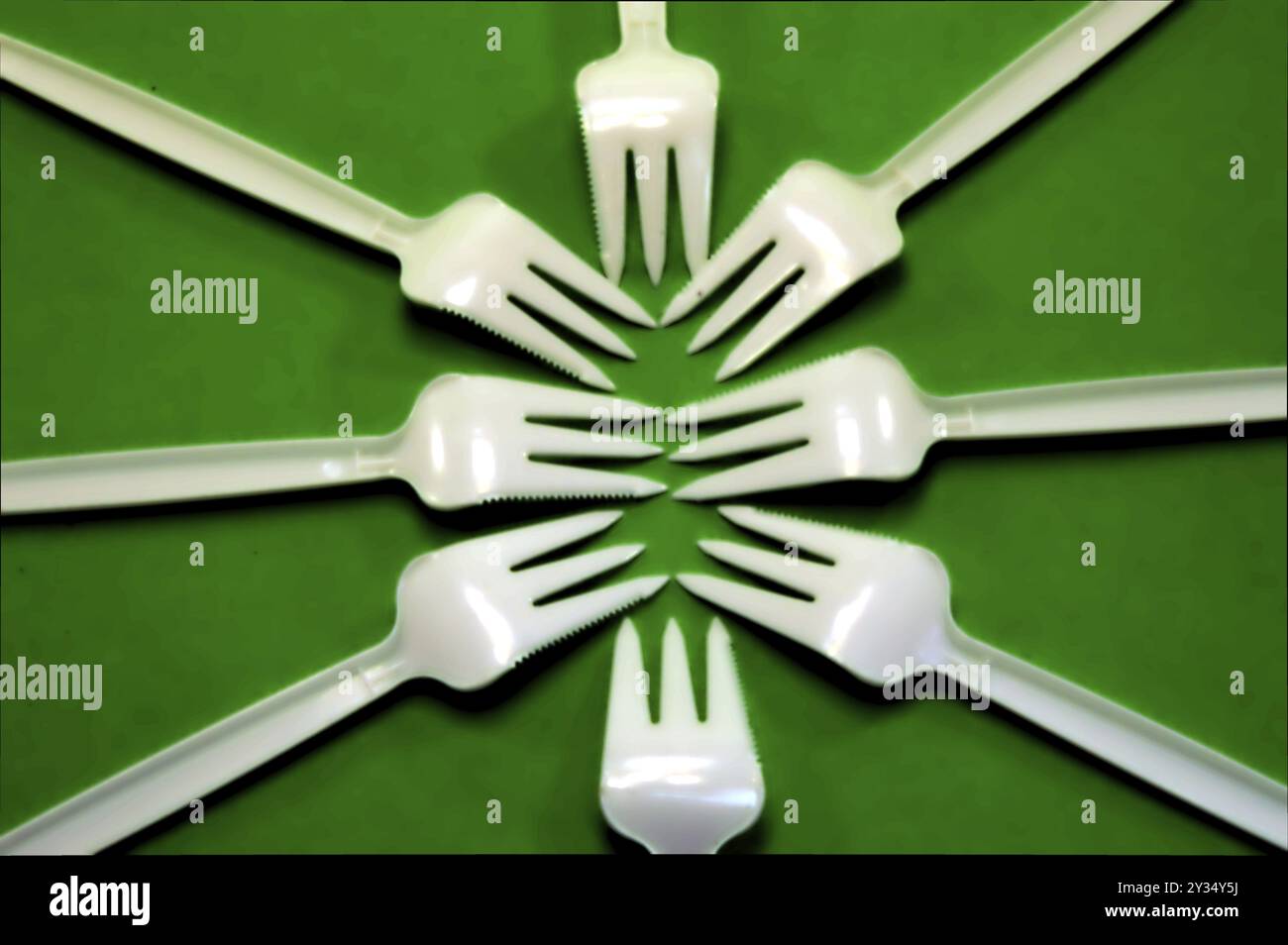Fork white with plastic snack bar on green bottom Stock Photo