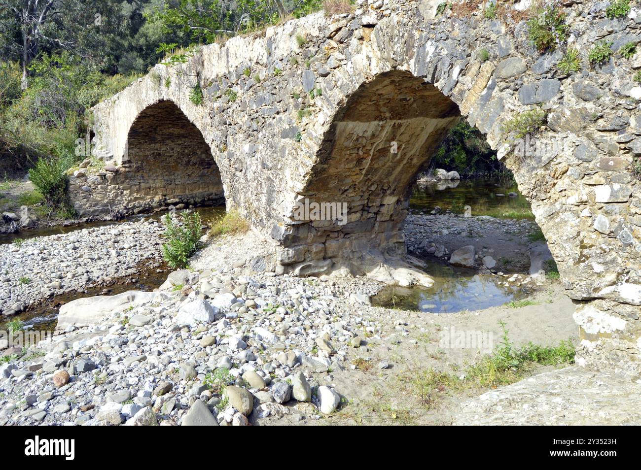 Very former bridge in stones with two arches Stock Photo