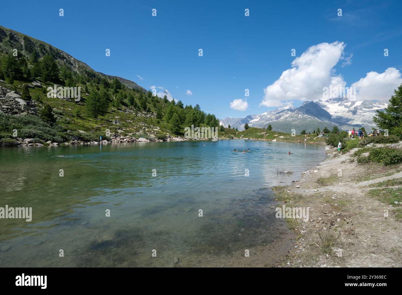 Zermatt, Switzerland - July 27, 2024: Grunsee Lake (Green Lake) along the Five Lakes Trail, a popular swimming hole Stock Photo