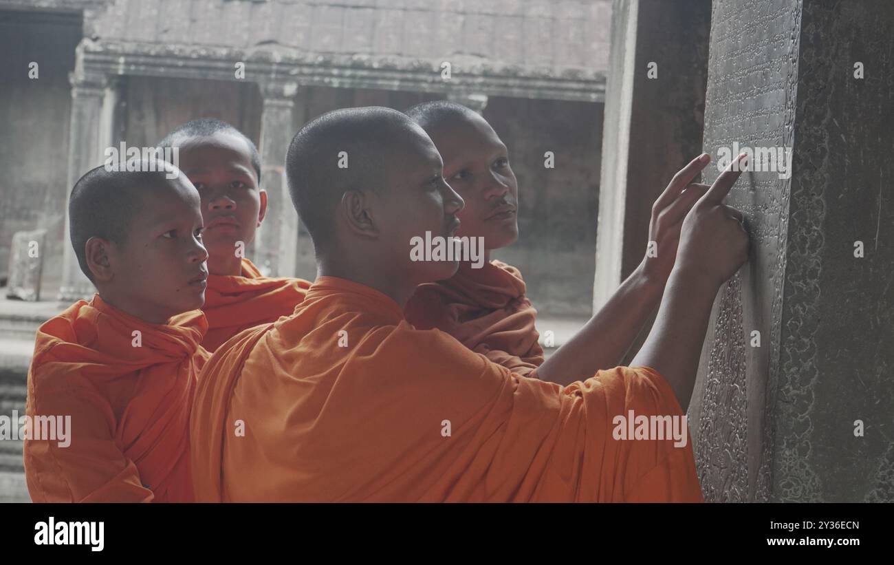 Young Monks Amidst the Majestic Temples of Angkor Wat Stock Photo