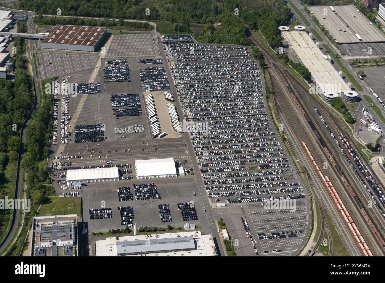 Hundreds of cars at the parking of Volkswagen plant are waiting to get transported to the dealerships. The carmaker has announced the closure of several plants. netherlands out - belgium out Stock Photo