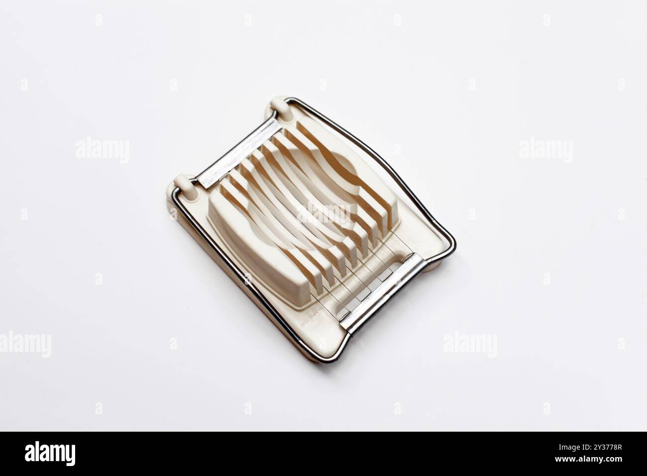 Egg Slicer kitchen utensil on white background Stock Photo