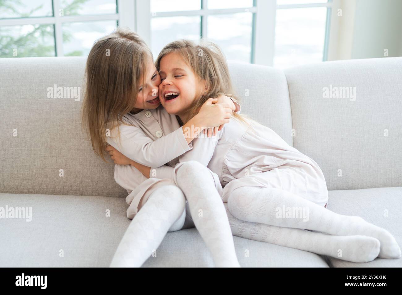 happy-family-sisterly-love-two-funny-little-twin-sisters-girls-hugging
