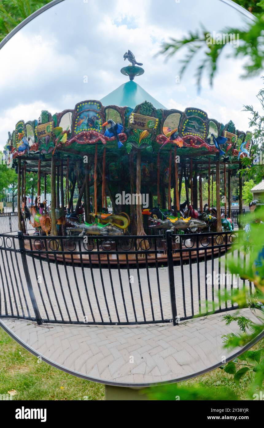 Mirror reflection of a carrousel ride in an amusement park Stock Photo