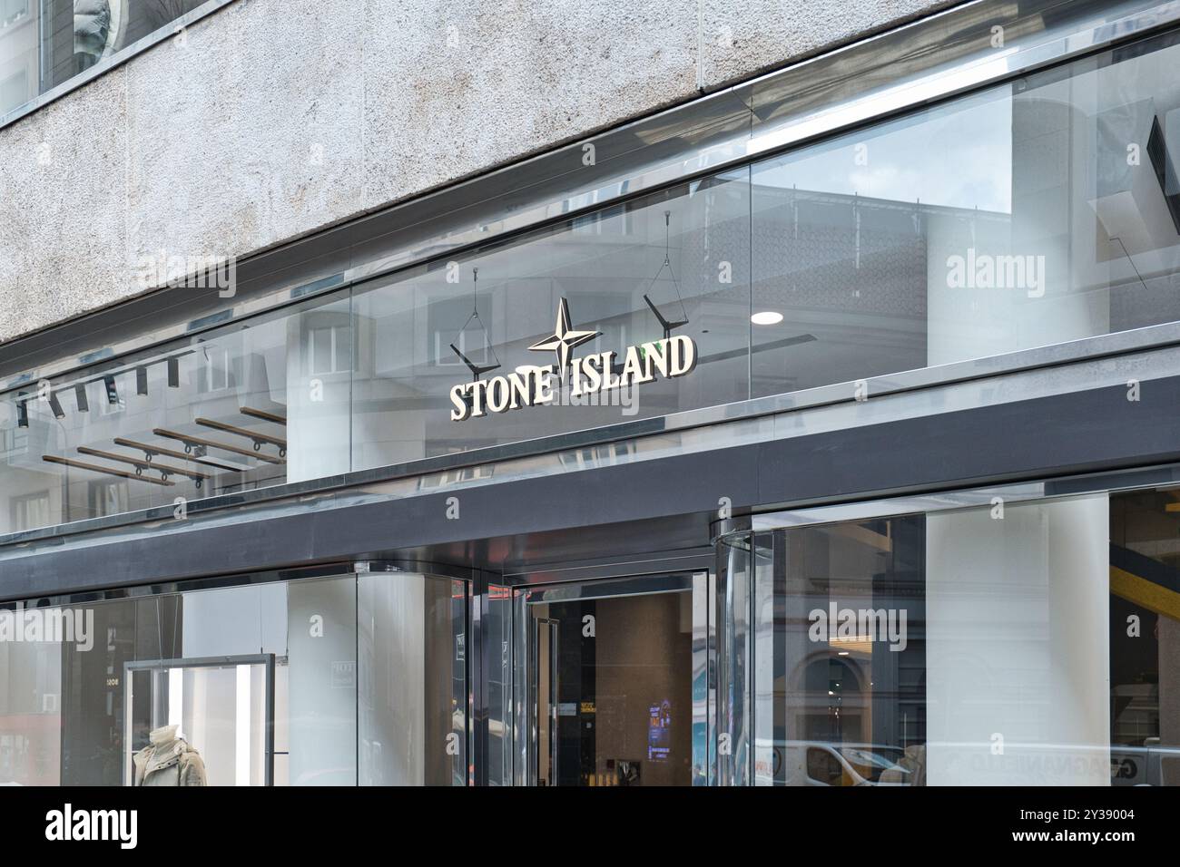 Stone Island window of flagship store in Milano Italy. An image with coloured man wearing a jacket. How colored african models are used in fashion Stock Photo Alamy