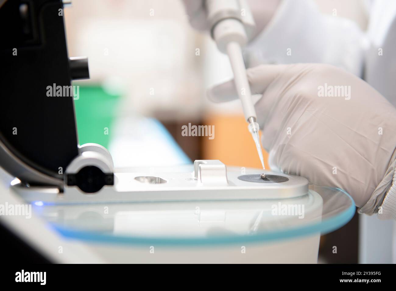 Tech Using Pipette Close up of lab tech using pipette with micro volume spectrophot Stock ...