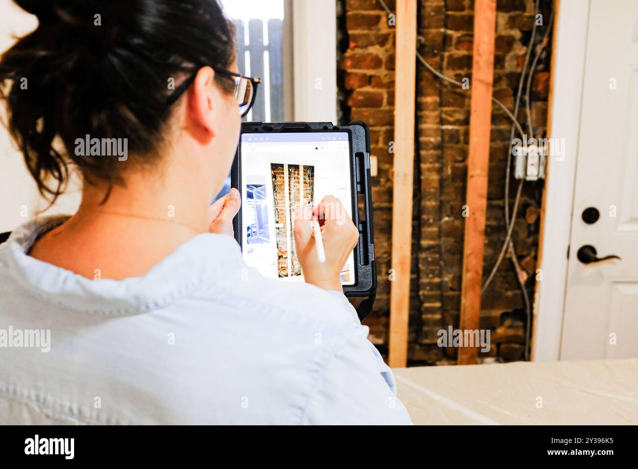Architect Using Digital Tablet for Home Repair Stock Photo