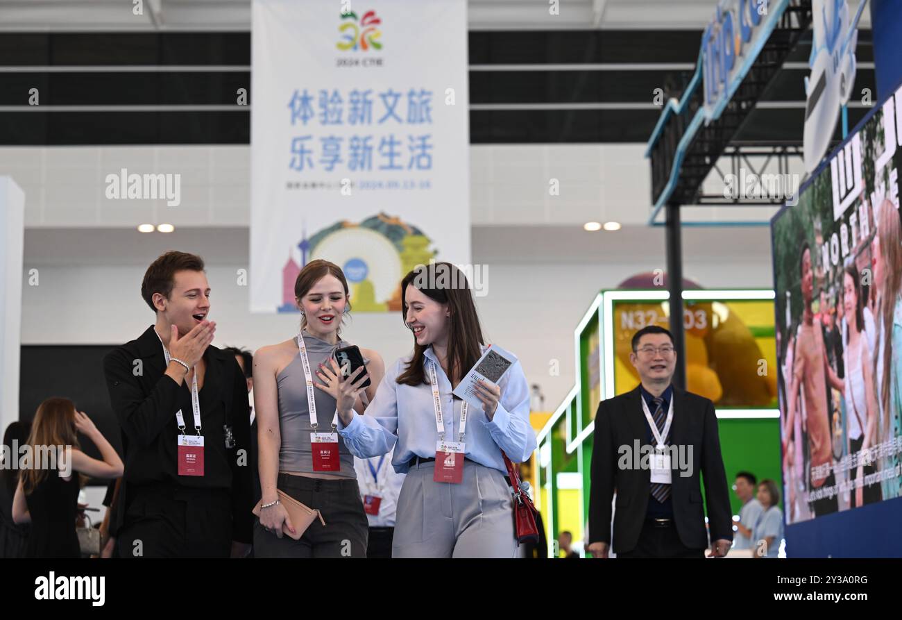 Tianjin. 13th Sep, 2024. People visit the 2024 China Culture and Tourism Industries Exposition in north China's Tianjin, Sept. 13, 2024. The four-day exposition opened here on Friday. Over 2,000 cultural and tourism enterprises are participating, with immersive experience spaces showcasing smart tourism and outdoor equipment, achievements in deep integration of culture and tourism, as well as development in innovative cultural products and services. Credit: Sun Fanyue/Xinhua/Alamy Live News Stock Photo