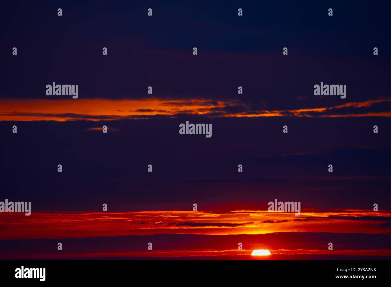 Radiant sunbeams streaming through soft clouds. Fantastic red clouds with twilight Stock Photo
