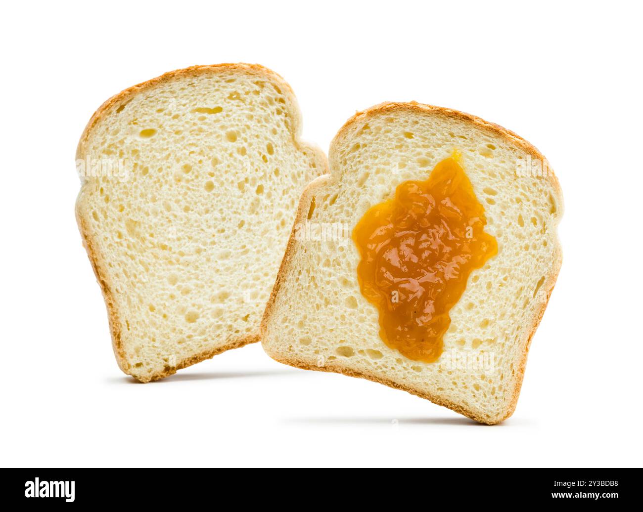 Slices of white bread with apricot jam spread on white background. Stock Photo