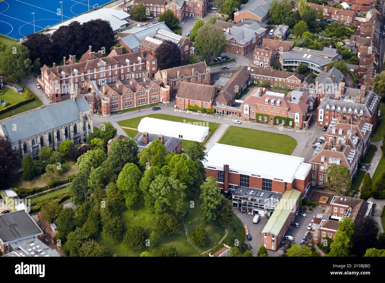 A detailed aerial view of a historic school campus surrounded by trees ...