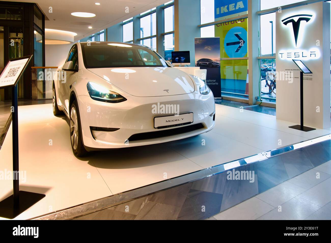 White Tesla Model Y Crossover battery electric vehicle car on a sales stand at Rio Shopping shopping mall Valladolid Castile and Leon Spain Stock Photo