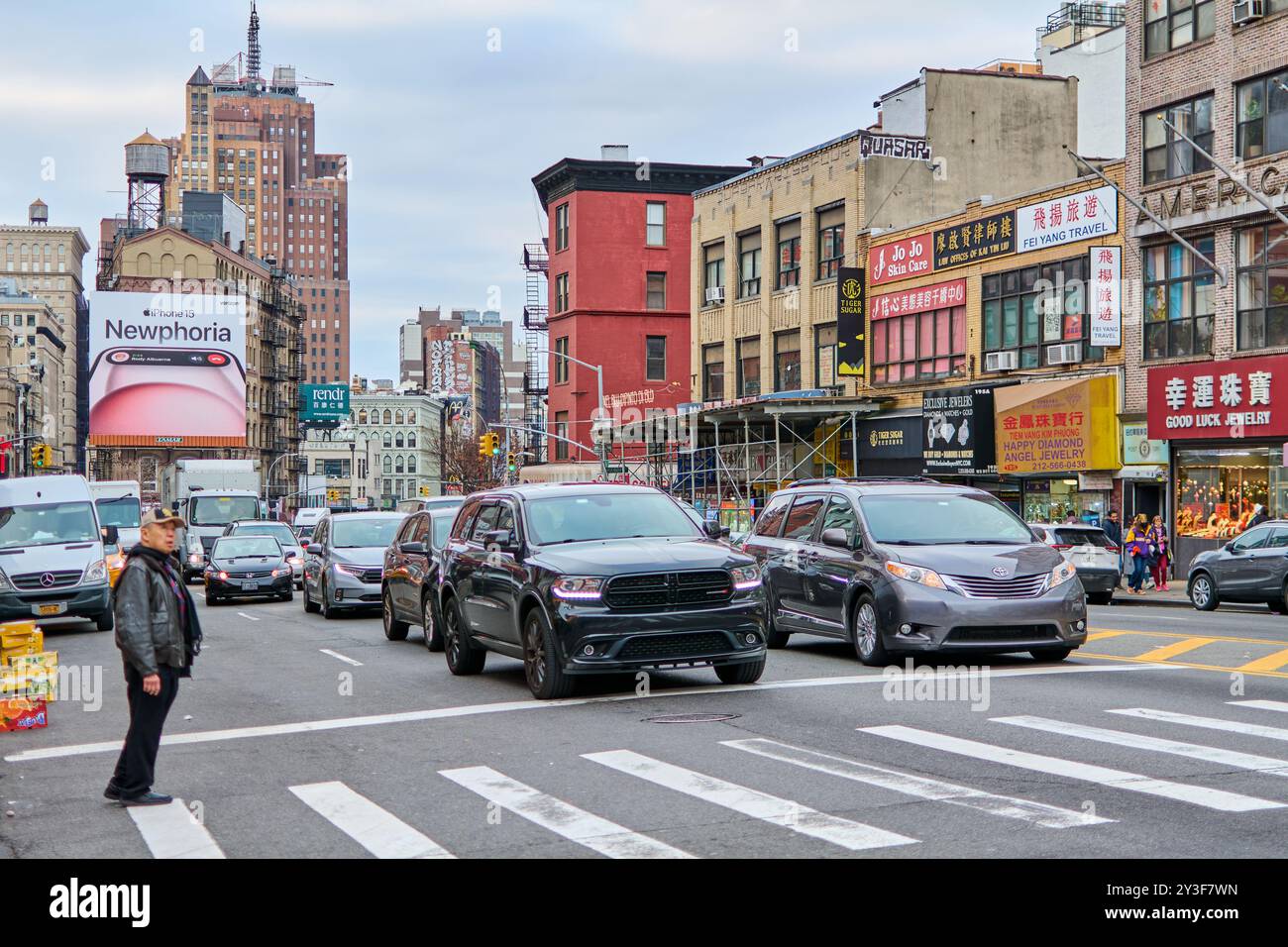 New York, United States -September 13,2024: The image captures the essence of Chinatown in New York, with a street filled with vehicles and a prominen Stock Photo