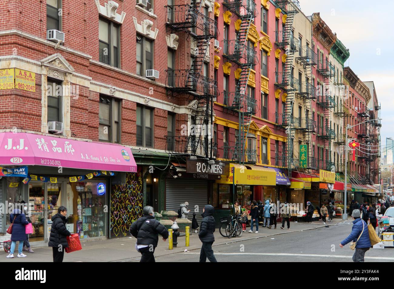 New York, United States -September 07,2024: A vibrant street scene in Chinatown, New York City, featuring pedestrians, colorful storefronts, and diver Stock Photo