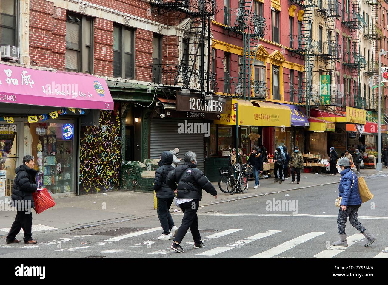 New York, United States -September 07,2024: An energetic street scene in Chinatown, New York City, showcasing pedestrians, colorful shop signs, and di Stock Photo