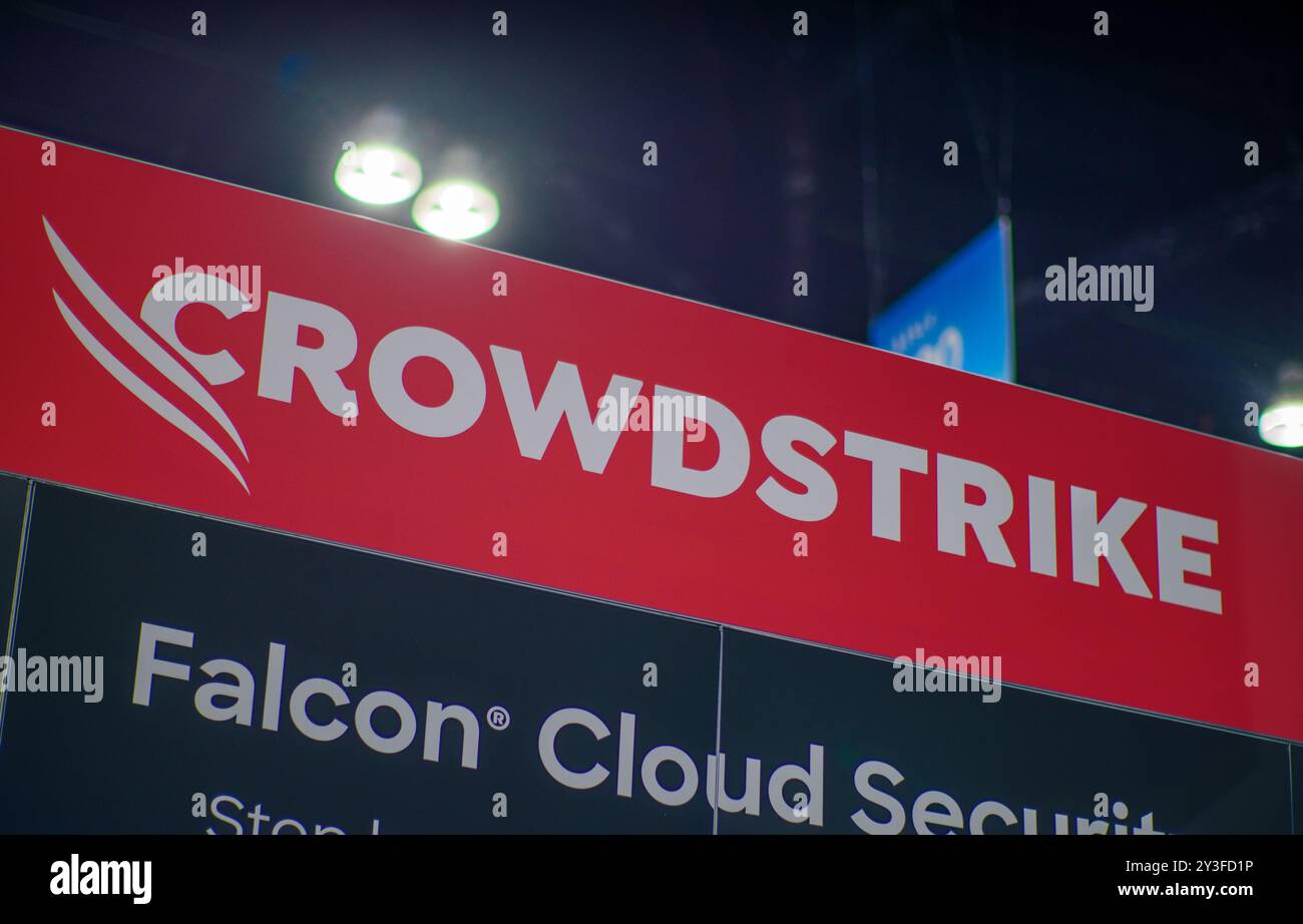 LOS ANGELES, CA- May 22, 2024: Crowdstrike logo on Crowdstrike's booth at AWS Summit in Los Angeles Convention Center. Stock Photo