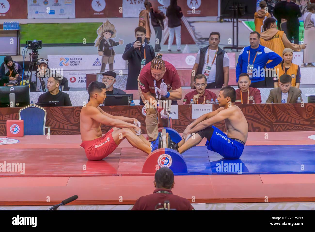 The mas-wrestling match, a traditional Kazakh sport, in Astana, Kazakhstan, during the World Nomad Games. Stock Photo