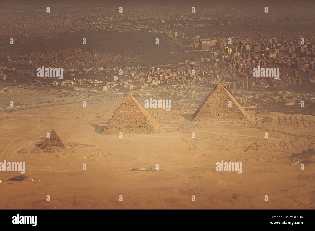 The aerial panorama view of Egyptian pyramids of Giza, with Giza town and Cairo city districts is seen in the background. Stock Photo