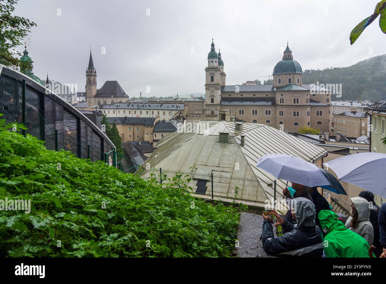 Salzburg: Salzburg Cathedral, rainy day, tourists in rain clothes and ...