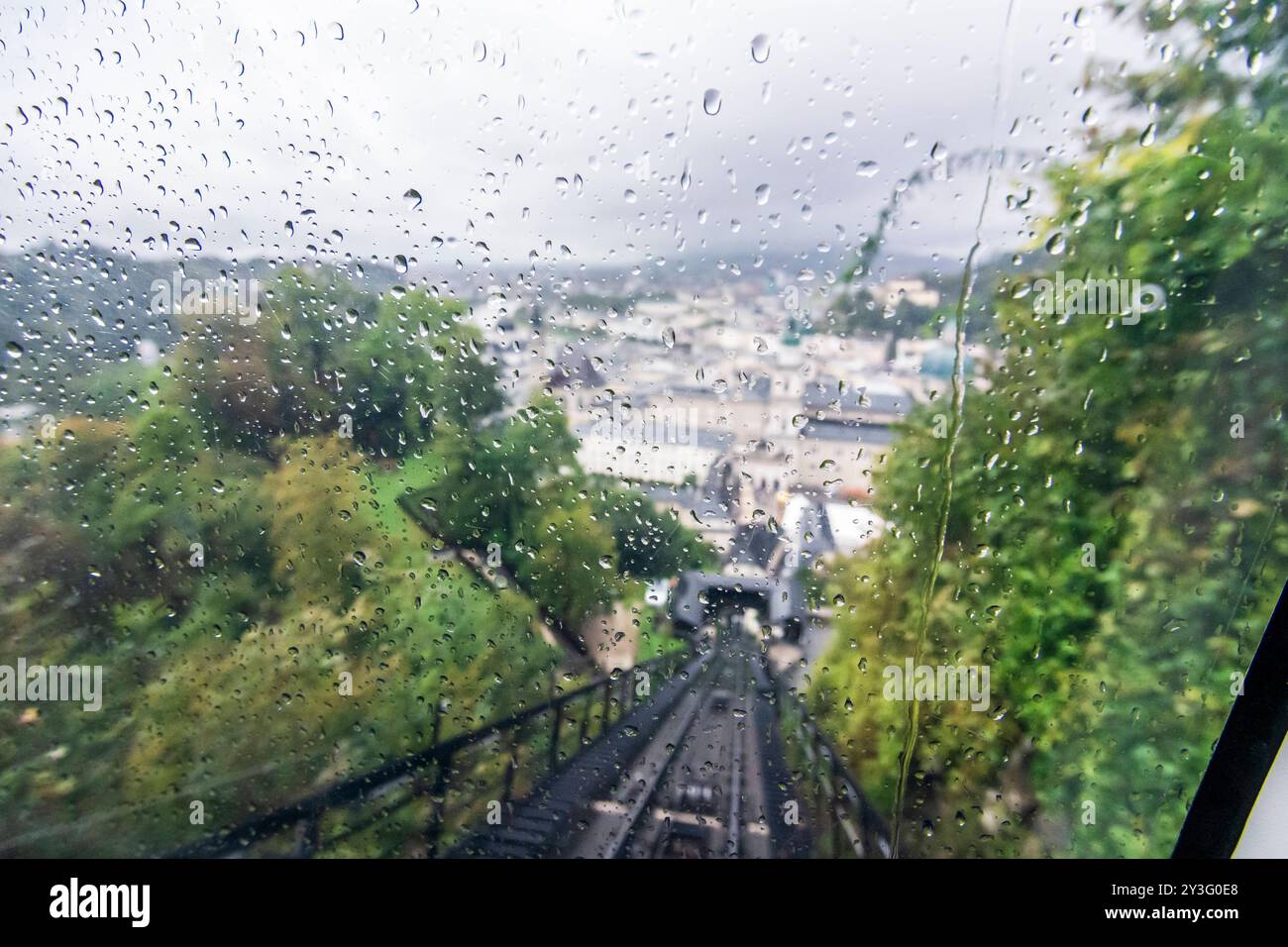 rain drops at window of Festungsbahn funicular railway, view to Old Town, rainy day Salzburg Flachgau Salzburg Austria Stock Photo