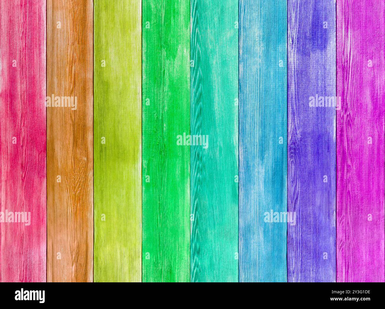 Rainbow coloured vibrant background texture - planks of wood in rustic fence style backdrop running the gamut of hues. Represenation of full spectrum. Stock Photo