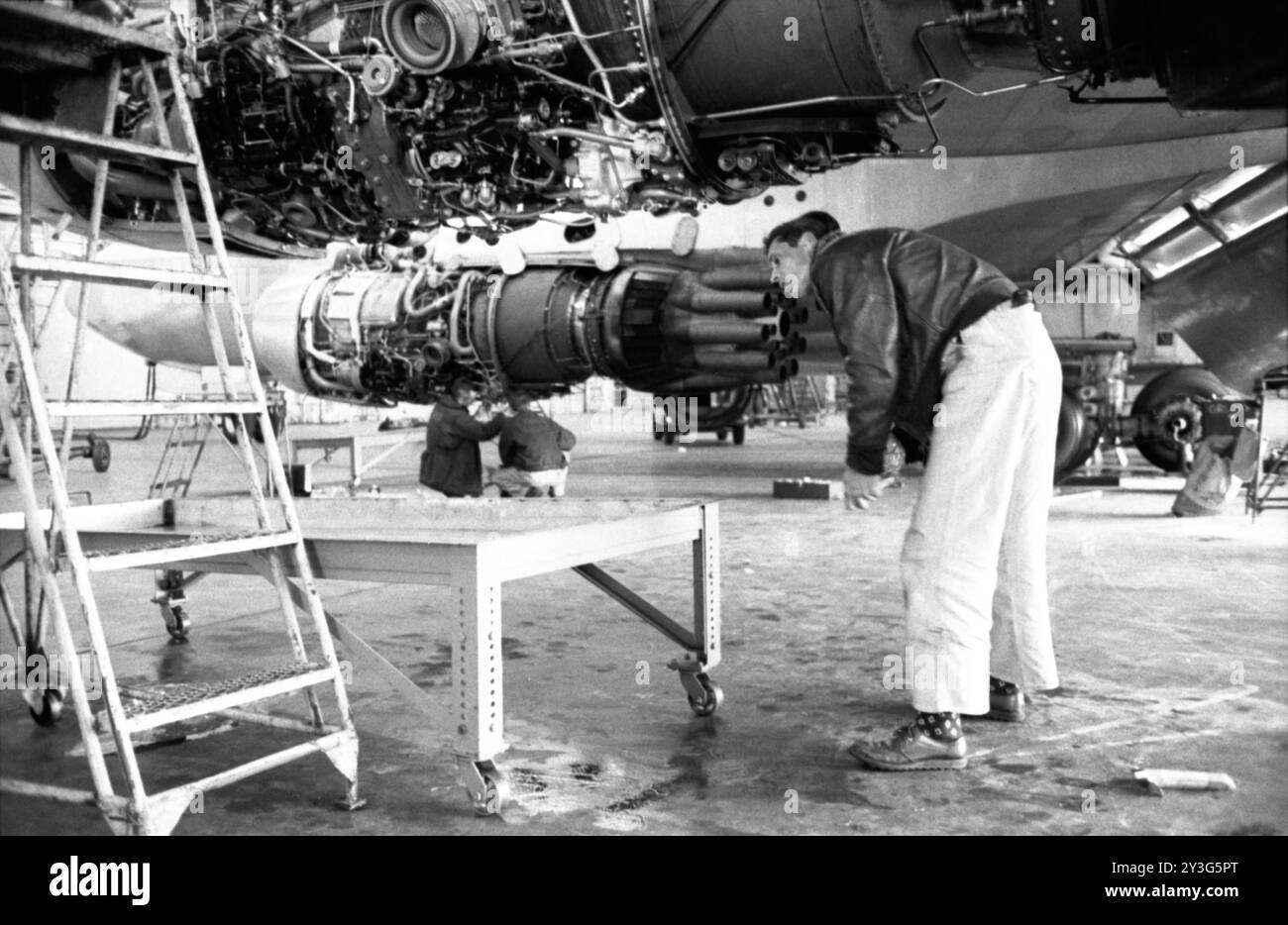 A worker works on a Trans World Airlines Boeing 707 jet at Idlewild Airport April 28, 1959. Stock Photo