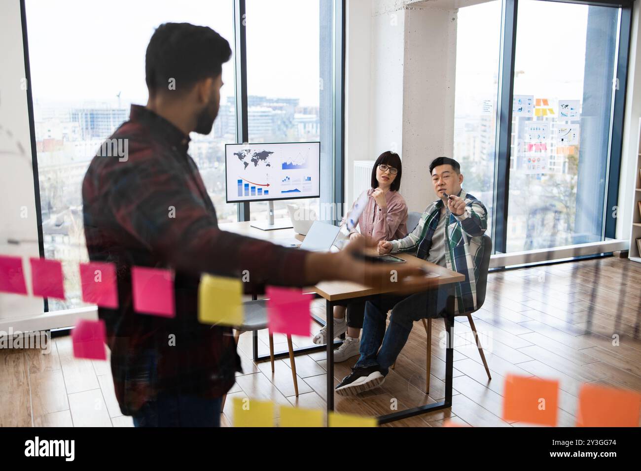Team brainstorming session in modern office with sticky notes and ...