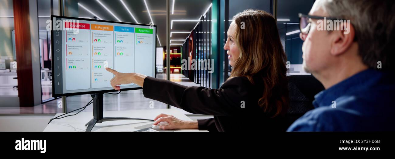 Scrum Project Manager Using Scrum Board Scheduling Software Stock Photo