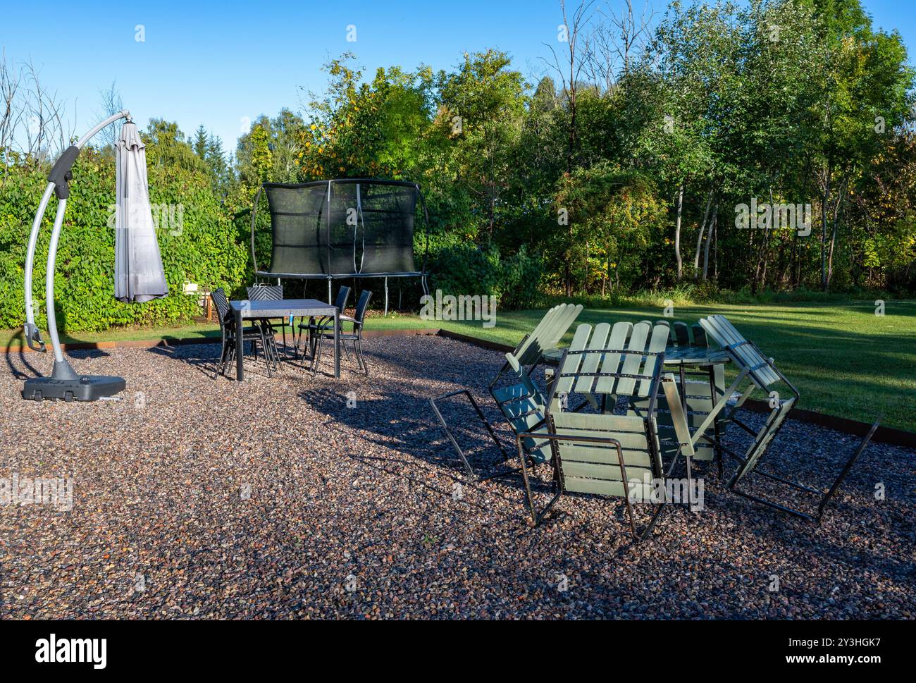 Early morning in garden with dew on lawn and furniture Stock Photo
