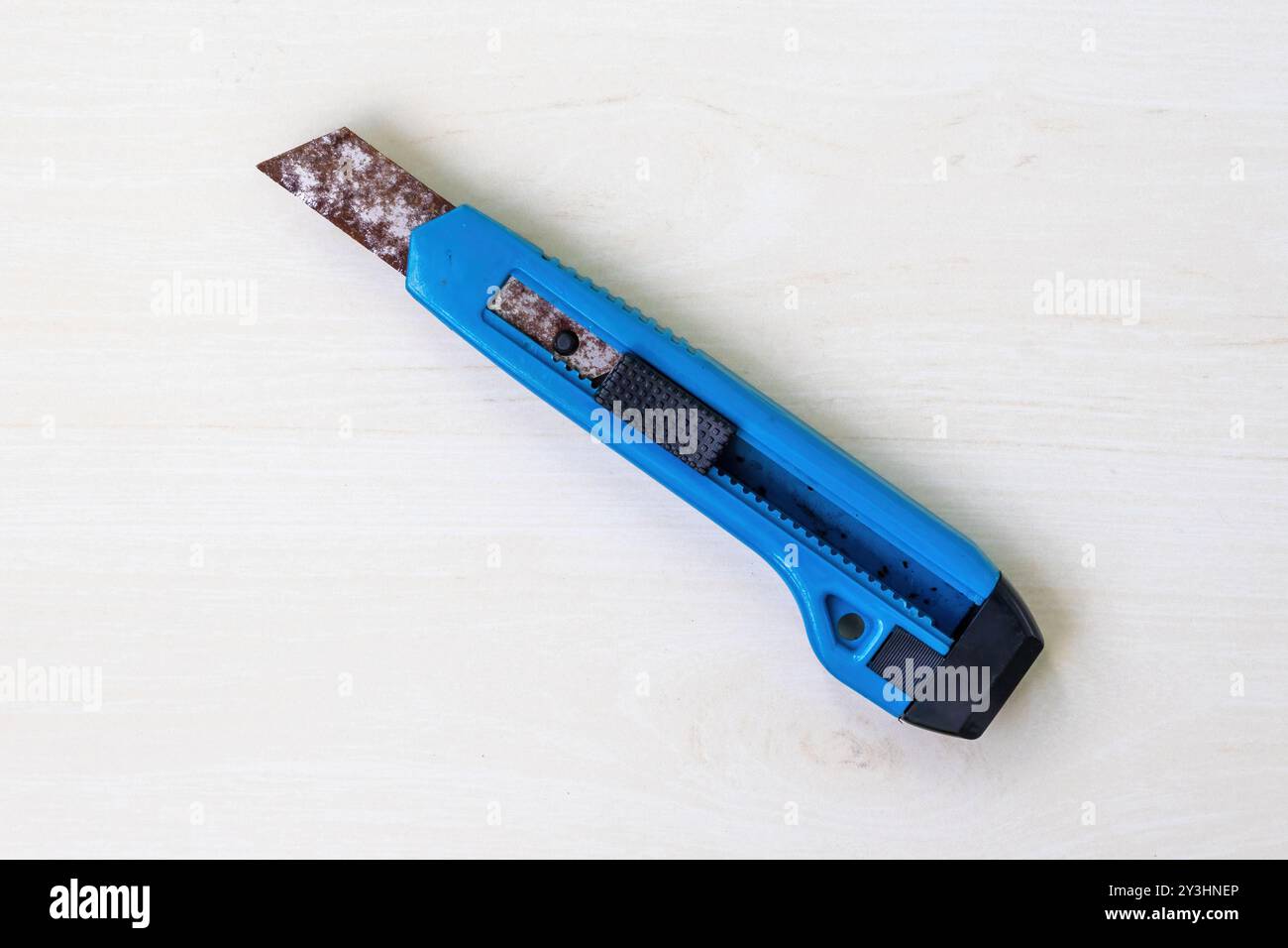 Rusty old knife on a light wooden surface. Stock Photo