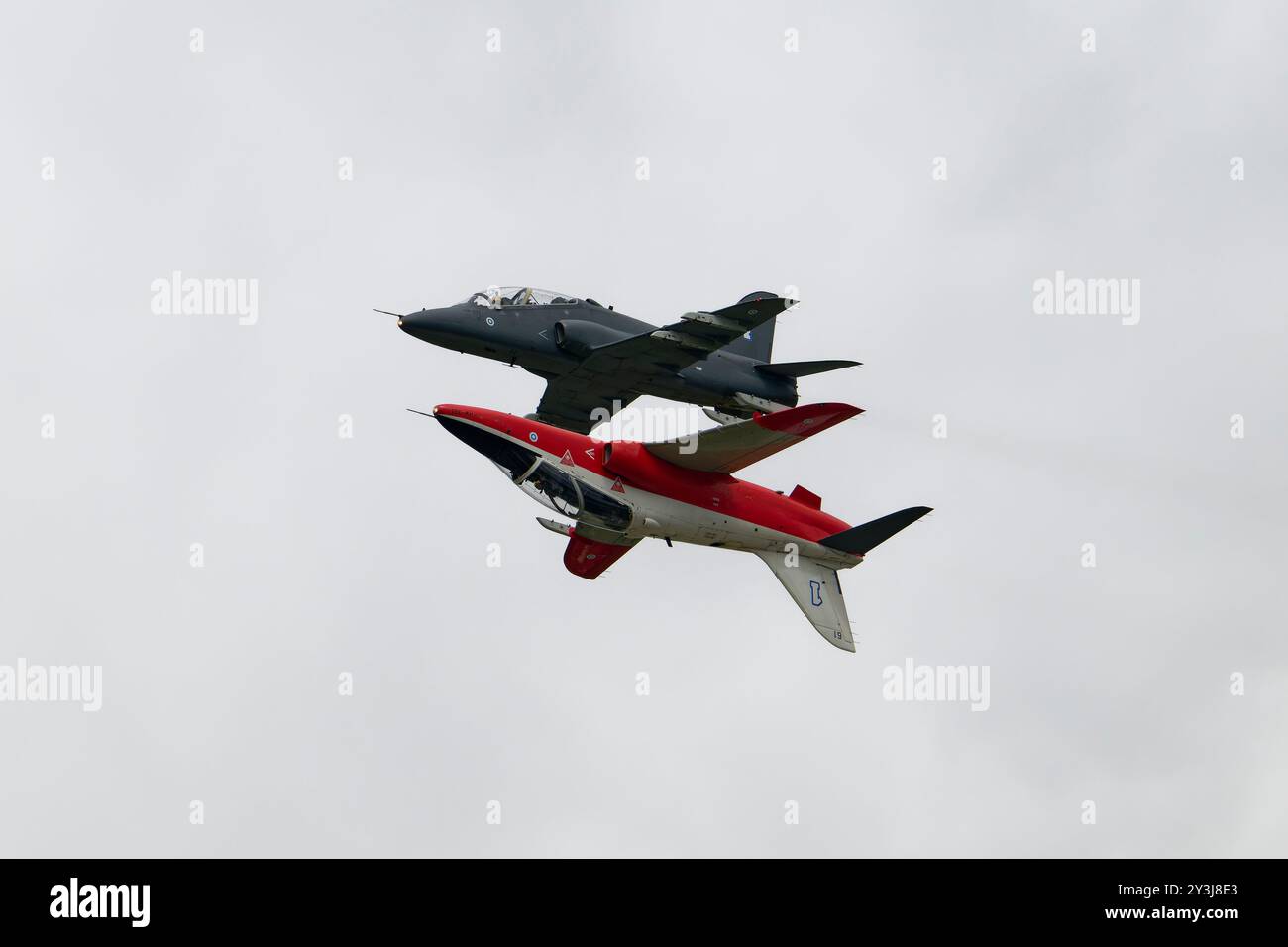 Two BAe Hawk Mk 66 Military Jet Trainers of the Finnish Air Force Midnight Hawks aerobatic display team fly in incredibly close formation at the RIAT Stock Photo
