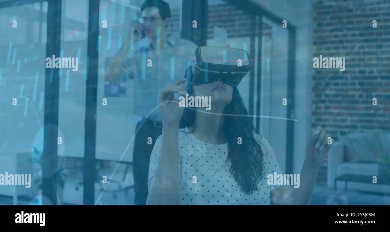 Using virtual reality headset, woman interacting with data visualization image Stock Photo