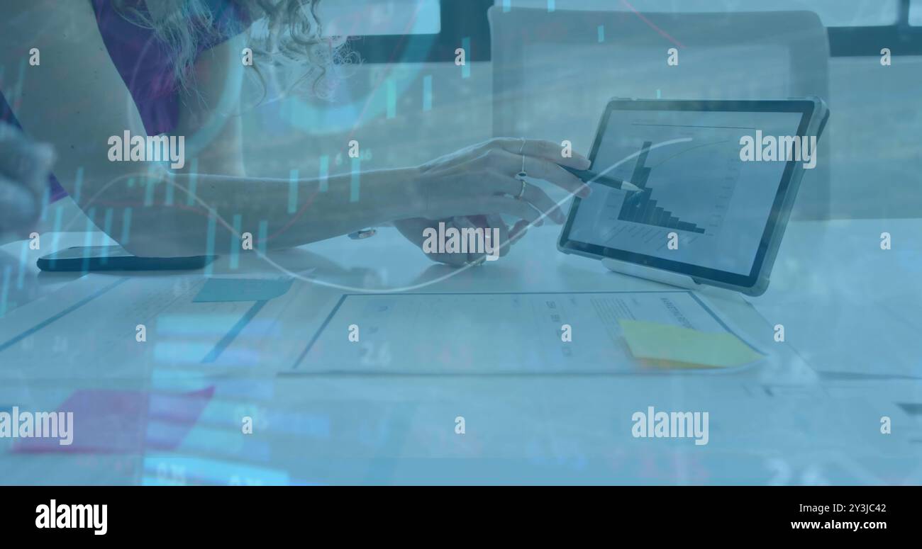 Financial data analysis image over person pointing at tablet with bar graph Stock Photo