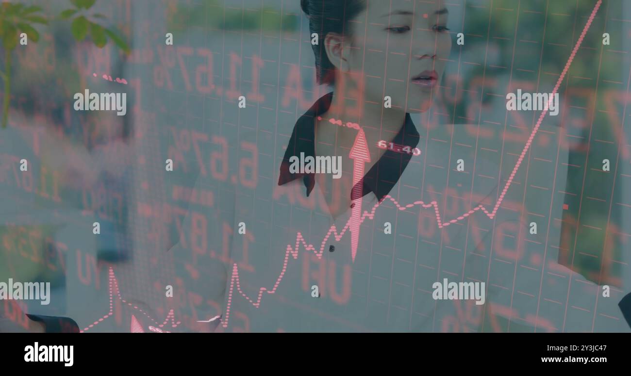 Image of financial data processing over asian businesswoman using computer Stock Photo